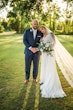 Groom with Bride in Beaded Chiffon Sheath Wedding Dress Called Lorraine by Rebecca Ingram