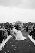 Bride wearing Tuscany Royale by Maggie Sottero kissing her husband at their ceremony