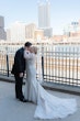 Bride wearing Riviera by Sottero and Midgley kissing her husband