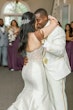 Newlyweds dancing closely.