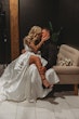 Bride Wearing Aline Satin Wedding Gown Called Scarlet By Maggie Sottero Sitting On Grooms Lap