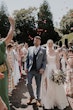 Bride wearing Scarlet by Maggie Sottero and her husband exiting their wedding