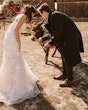 Bride wearing Bridget by Maggie Sottero and her husband petting a donkey