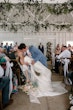 Bride wearing Mitchell by Maggie Sottero kissing her husband