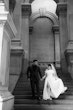 Bride Wearing Modern Ballgown Wedding Dress Called Aspen By Sottero And Midgley Holding Hands With Groom Walking Down the Stairs