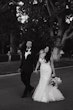 Bride wearing Hattie Lynette wedding dress by Rebecca Ingram walking with her husband