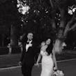 Bride wearing Hattie Lynette wedding dress by Rebecca Ingram walking with her husband