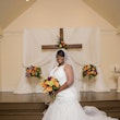 Bride with colorful bright bouquet in wedding dress called Veda.