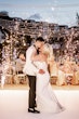 bride and groom kissing on dance floor.