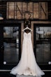 Ballerina-inspired Romantic Wedding Dress Called Fairbanks By Maggie Sottero Hanging From A Window