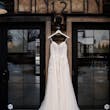 Ballerina-inspired Romantic Wedding Dress Called Fairbanks By Maggie Sottero Hanging From A Window