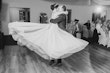 Groom Kissing Bride In White Wedding Dress Named Shasta By Sottero and Midgley