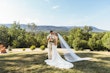 Bride wearing Albany wedding dress by Maggie Sottero standing with her husband