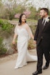 Bride wearing Clover by Rebecca Ingram walking with her husband