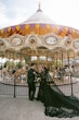 Bride Wearing Black Lace Wedding Dress Called Zander Lane By Sottero And Midgley With Groom In Front Of A Carousel