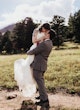 Bride Wearing Sexy Lace Wedding Dress Called Hazel By Rebecca Ingram Being Lifted Up By Groom