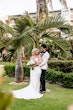 bride and groom looking at each other smiling.