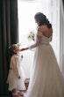 Bride wearing Nerida by Sottero and Midgley with her flower girl