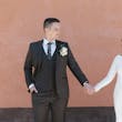 Bride wearing Aston by Sottero and Midgley holding hands with her husband