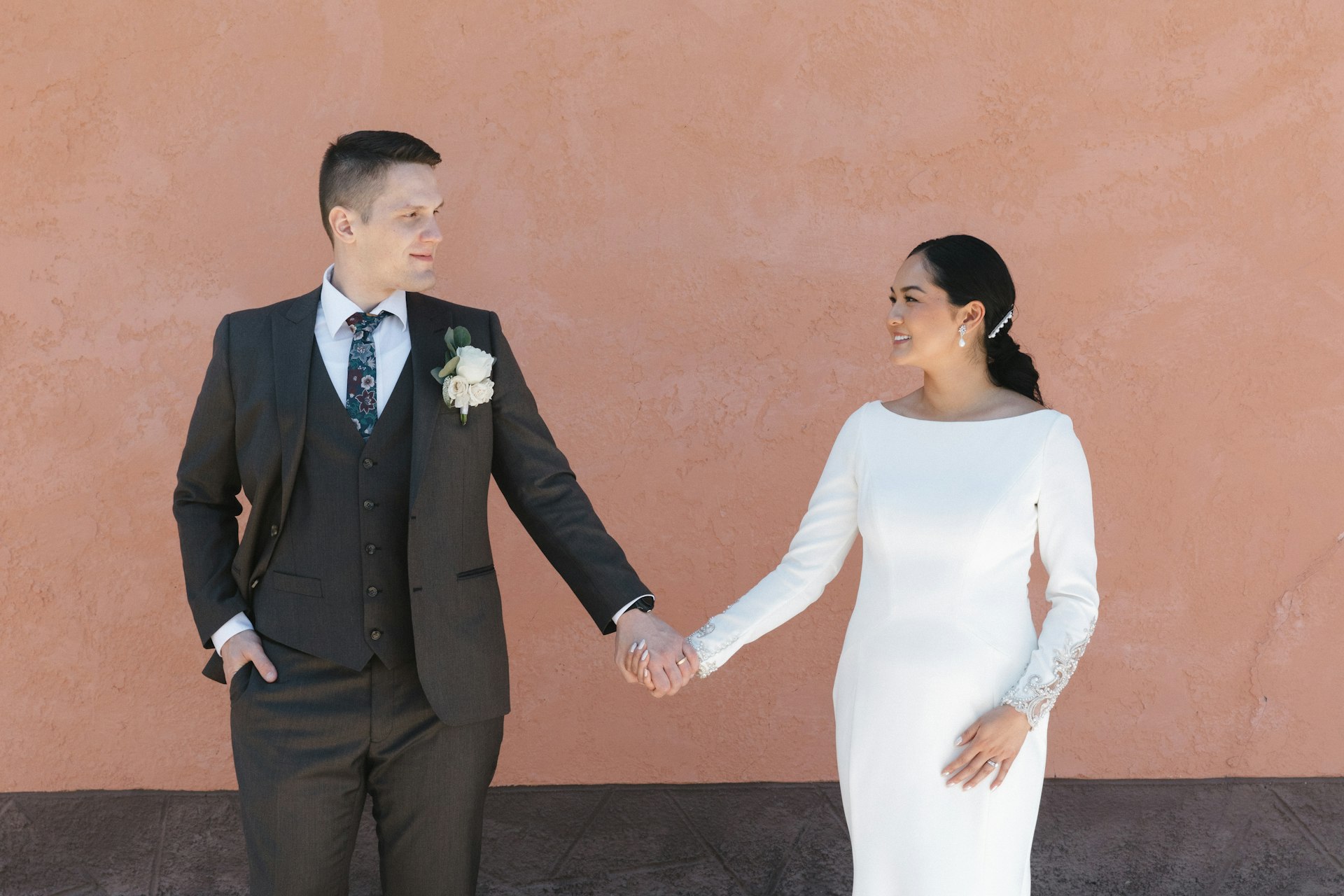 Bride wearing Aston by Sottero and Midgley holding hands with her husband