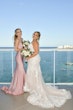 Bridesmaid with Bride in Lovely Plus Size Fit-and-Flare Tulle Wedding Dress with Delicate Lace Motifs Accented with Beading Called Glorietta Lynette by Maggie Sottero