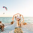 Bride Wearing Boho Sleeved Wedding Dress Called Quintyn By Maggie Sottero At The Ceremony On The Beach