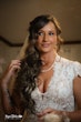 Bride wearing Kingsley wedding gown by Sottero and Midgley fixing her hair