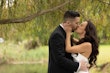 Bride wearing Mitchell Marie by Maggie Sottero kissing her husband