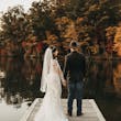 Bride Wearing Lacey Sheath Long Sleeve Wedding Dress Called Francesca By Maggie Sottero Standing With Groom On Dock Looking Over Water