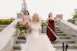 Bride wearing Laila wedding dress by Maggie Sottero walking down the stairs with her bridesmaids