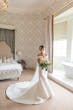 Bride Wearing Simple Off-the-shoulder Wedding Dress Called Josie By Rebecca Ingram In A Lux Bathroom 