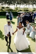 Bride wearing Tatiana wedding dress by Maggie Sottero with her guests and husband