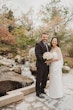 Bride wearing Clover by Rebecca Ingram with her husband