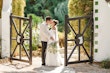 Bride Wearing Aline Wedding Dress Called Nerida By Sottero And Midgley Kissing Groom Next To A Gate