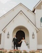 Bride Wearing Sparkly Ballgown Wedding Dress Called Zartasha By Sottero and Midgley With Groom In Front Of A Church