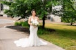 Real Bride Posing In White Wedding Dress Named Bailey By Sottero And Midgley Outside With Flowers