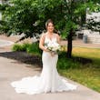 Real Bride Posing In White Wedding Dress Named Bailey By Sottero And Midgley Outside With Flowers