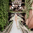 Bride stood on railway track wearing Alistaire wedding dress.