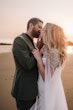 Bride wearing Summer wedding dress by Maggie Sottero kissing her husband