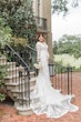 Bride In Long Sleeve Sheath Wedding Dress Called Cruz By Sottero And Midgley With Simple Bouquet