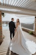 Bride wearing Aspen by Sottero and Midgley holding hands with her husband