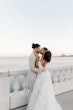 Bride wearing Lettie by Rebecca Ingram kissing her husband