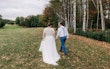 Bride Wearing Boho Wedding Dress Called Lorraine Dawn By Rebecca Ingram Walking With Grooom