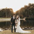 Bride Wearing Lacey Sheath Long Sleeve Wedding Dress Called Francesca By Maggie Sottero Holding Floral Bouquet With Groom Near Water