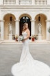 Bride Wearing Lace Mermaid Wedding Gown Called Montgomery By Sottero and Midgley Holding Bouquet