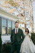 Bride Wearing Floral Ballgown Wedding Dress Called Derrick Marie Standing Behind Groom