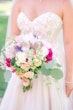 Bride In White Wedding Dress Named Shasta By Sottero and Midgley With Veil And Pink Flowers