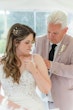 Bride wearing Nikki by Maggie Sottero being zipped up