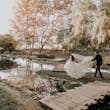Groom And Bride Walking Together. Bride Wearing Lace Ball Gown Called Mallory Dawn By Maggie Sottero