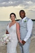 Bride wearing Franklynn by Sottero and Midgley with her husband on the beach